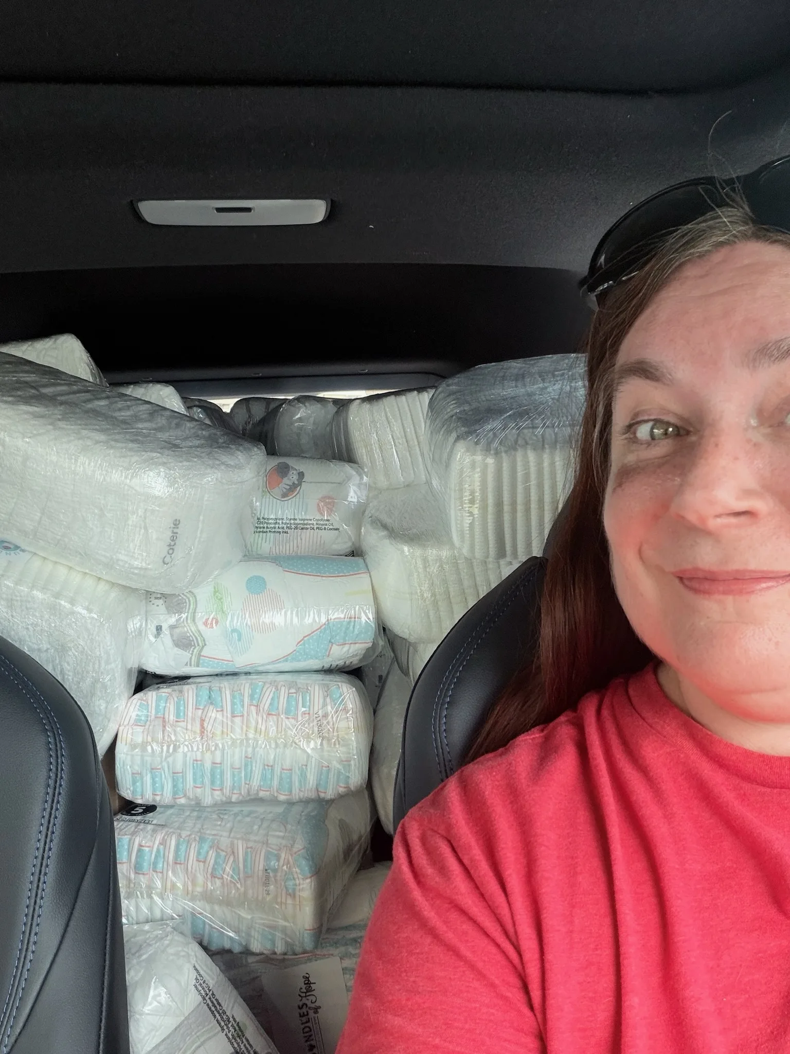 Summer Jennings with a car full of diapers from Bundles of Hope