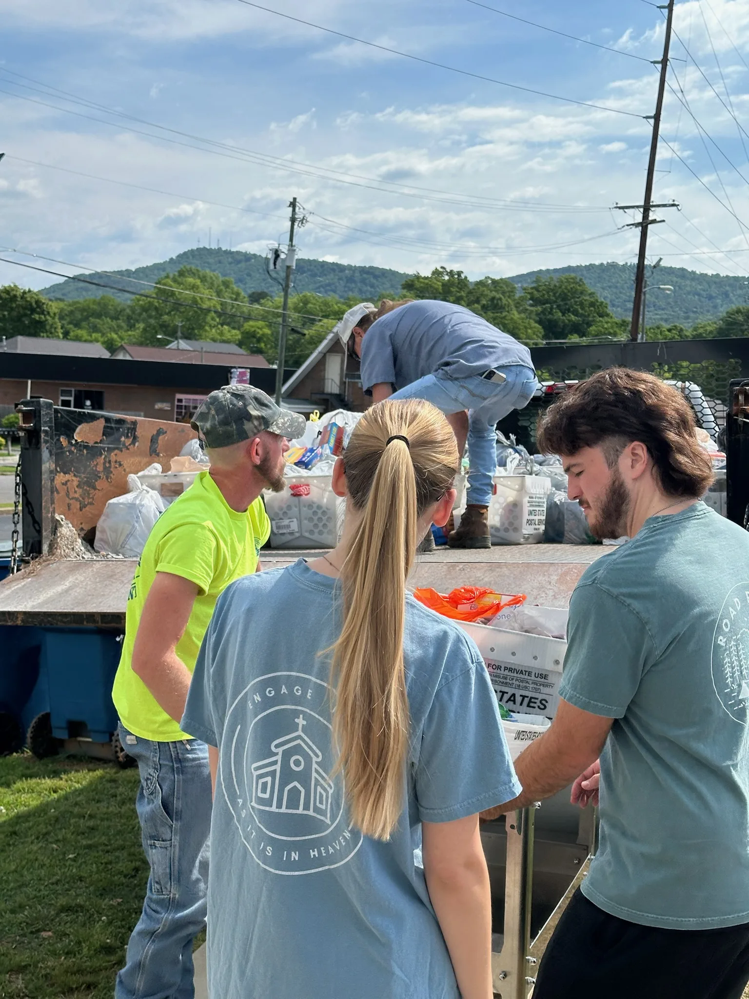 Volunteers unloading donated food from a truck